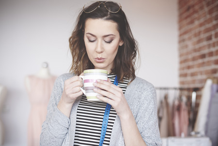 Fashion female designer enjoying coffeeの写真素材