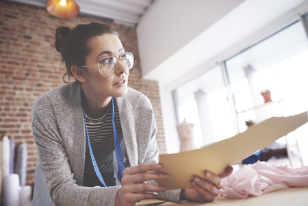 Tailor with patterns looking awayの写真素材