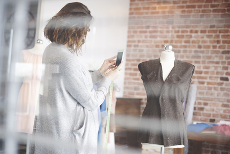 Tailor photographing her new projectの写真素材