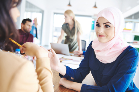 Muslim female coworker carefully listening to adviceの写真素材