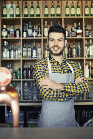 Portrait of bartender crossing armsの写真素材