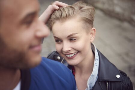 Smiley woman with hands in hairの写真素材
