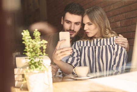 Young couple using mobile deviceの写真素材