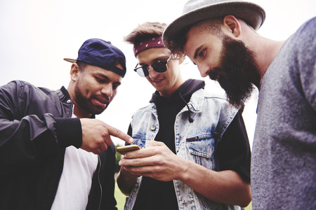 The best buddies looking at mobile phoneの写真素材