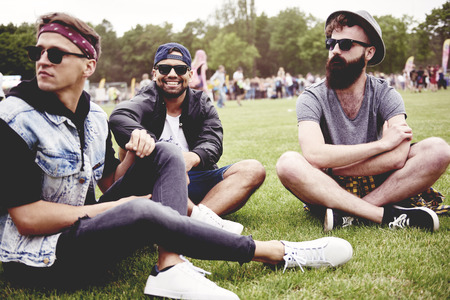 Man sitting on the grass before start a concertの写真素材