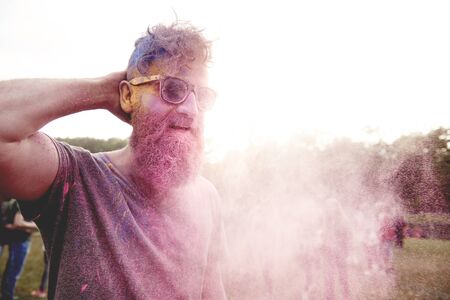 Pink powder on the man at the festivalの写真素材