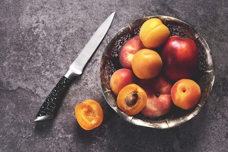 Ripe sweet peach in the bowlの写真素材