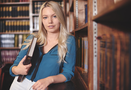 Pretty woman in a college libraryの写真素材