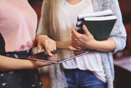 Unrecognizable woman using digital tablet in libraryの写真素材