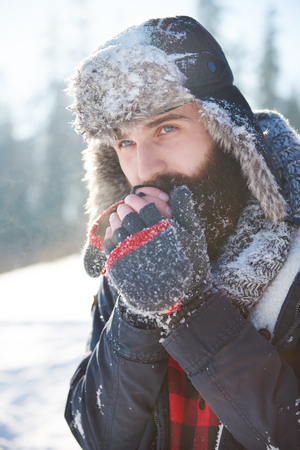 Frozen hands of man with beardの写真素材