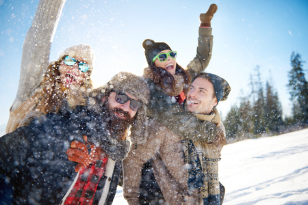 Friends having fun in the snowの写真素材