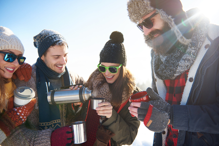 Warming up with tea on the thermosの写真素材