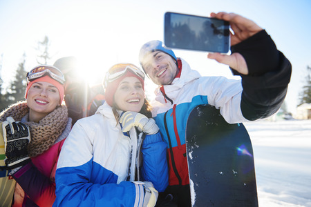 Group of friends taking photo on the mountains