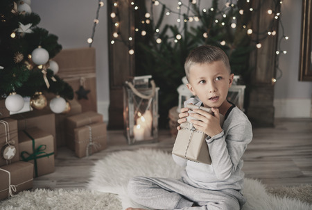 Child hugging a christmas presentの写真素材