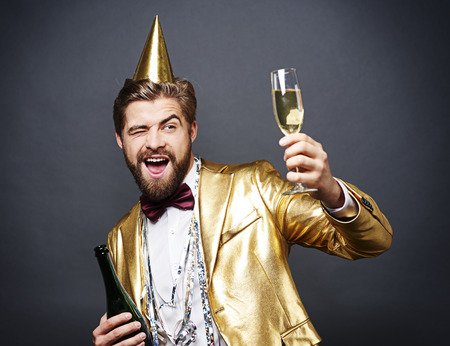 Man with birthday hat toastingの写真素材