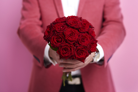 Unrecognizable man giving bunch of rose の写真素材