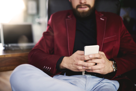 Unrecognizable businessman using his a mobilephone の写真素材