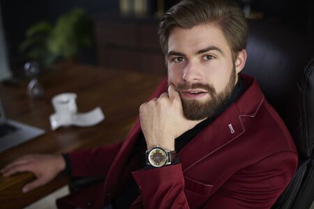 Portrait of businessman sitting at desk の写真素材