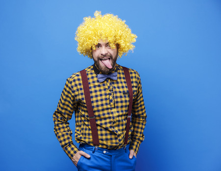 Man with wig sticking tongue out