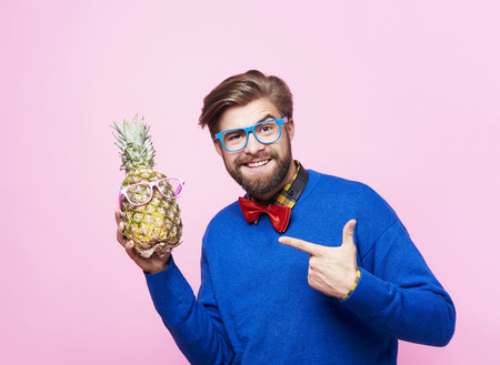 Funny man posing with pineappleの写真素材