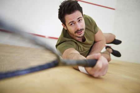 Player reaching for the squash ballの写真素材