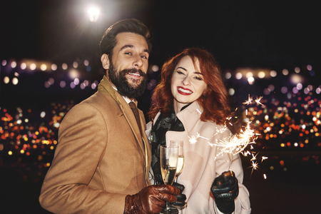 Portrait of elegant couple with champagne outdoors の写真素材