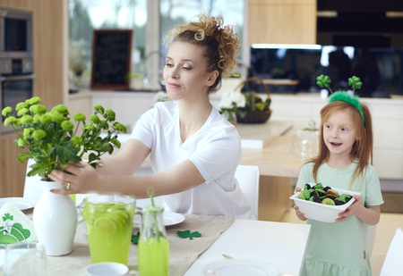 Mother with child make preparations for Saint Patrick's Dayの写真素材