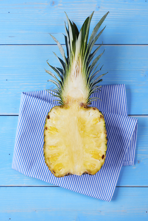 Half of pineapple on wooden table 
の写真素材