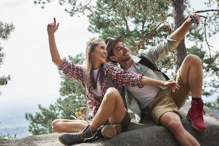 Couple making a selfie during hiking tripの写真素材