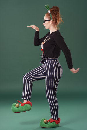 Playful woman in christmas clothes