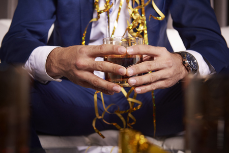 Unrecognizable man holding glass of whiskeyの写真素材
