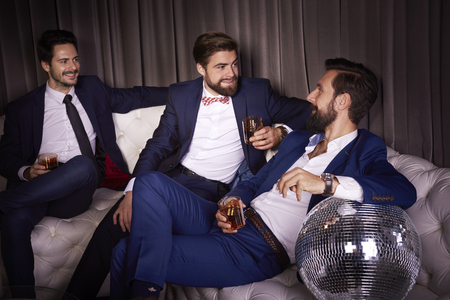 Male friends celebrating new year's eveの写真素材