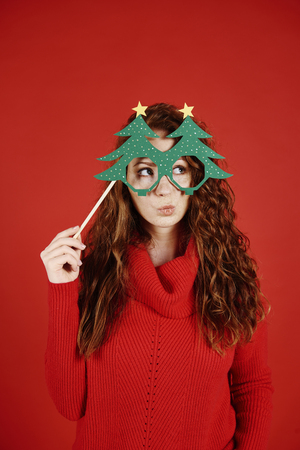 Girl with christmas mask looking at copy spaceの写真素材