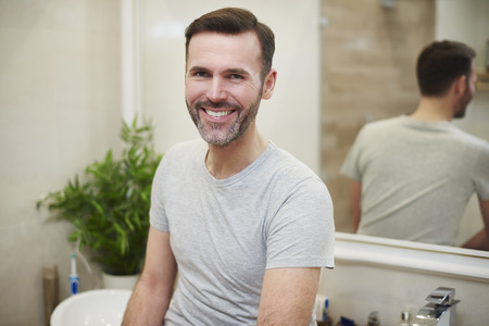 Portrait of smiling man in the bathroomの写真素材