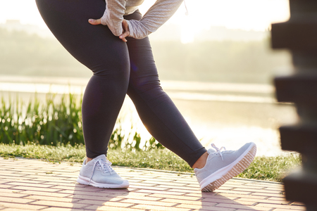 Low section of woman stretching her legsの写真素材