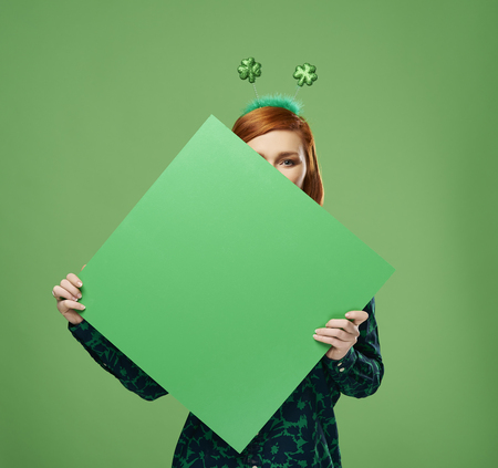 Woman's hands holding banner with copy space in studio shotの写真素材