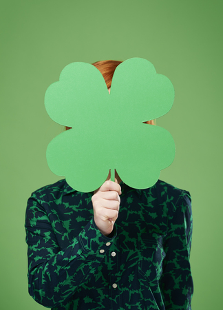 Woman's hand holding a four leaf cloverの写真素材