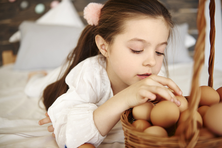 Focused girl watching the eggsの写真素材