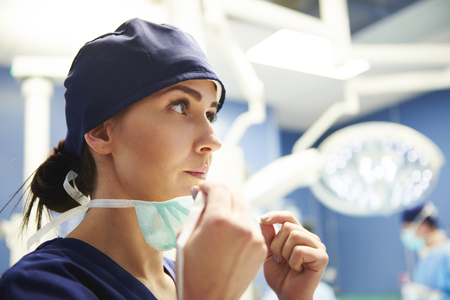 Female surgeon preparing for the operation の写真素材