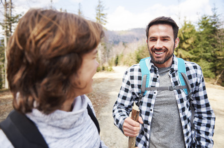 Smiling man with backpack hikingの写真素材