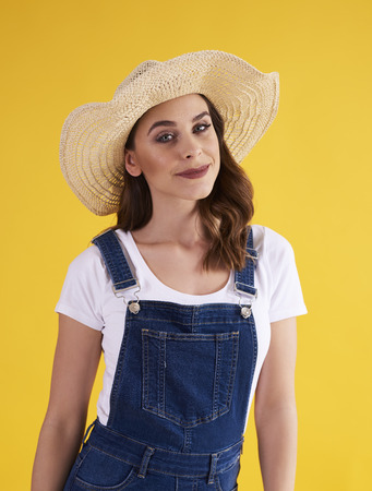 Portrait of beautiful woman in hat in the studio shotの写真素材