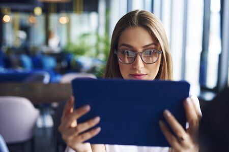 Focused, young woman using tabletの写真素材