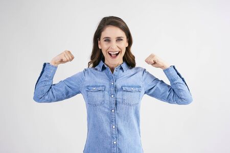 Confident and strong woman showing her bicep