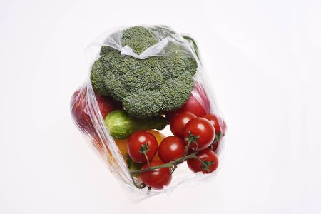 Plastic bag of vegetables on white background の写真素材