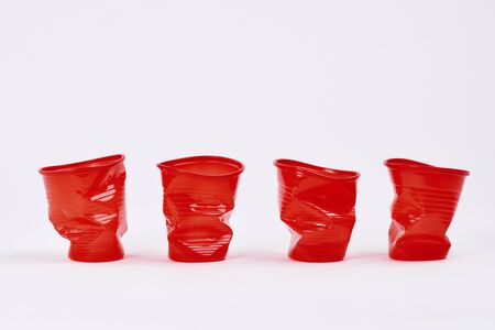 Four disposable plastic cups on white backgroundの写真素材