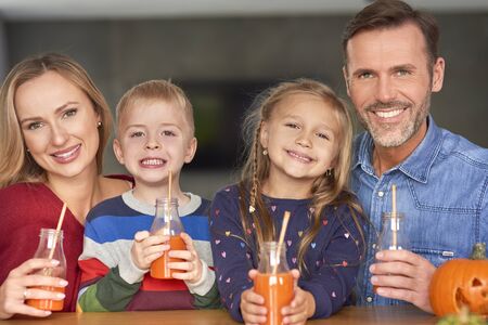 Portrait of smiling family drinking smoothie  