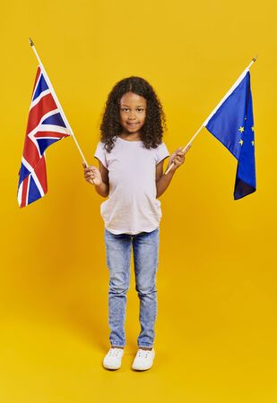 African girl holding British and European Union flags の写真素材