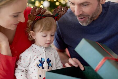 Family starting Christmas from opening presents