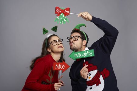 Nerdy man kissing disgusted womanの写真素材