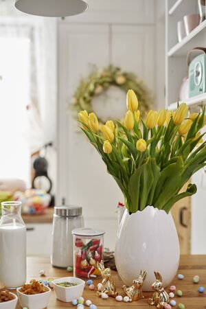Fresh tulips and baking ingredients on wooden table の写真素材